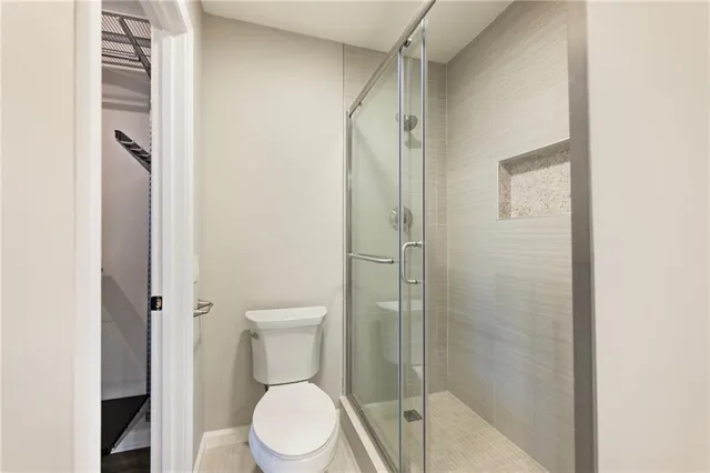 a white toilet sitting next to a bathroom sink