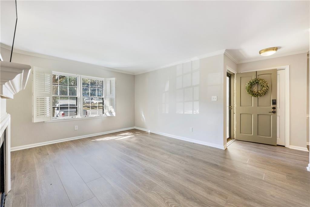 162 Amherst Place Northwest Atlanta, GA 30327 - Photo 5 of 24 an empty room with wooden floor and windows