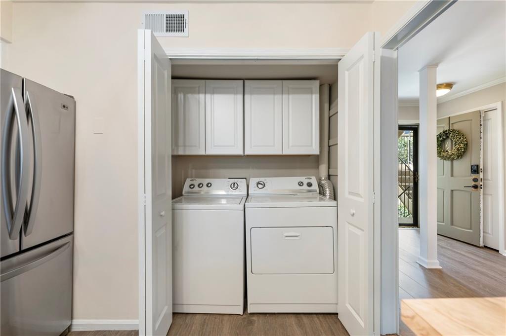 162 Amherst Place Northwest Atlanta, GA 30327 - Photo 8 of 24 a view of a kitchen with refrigerator and wooden floor