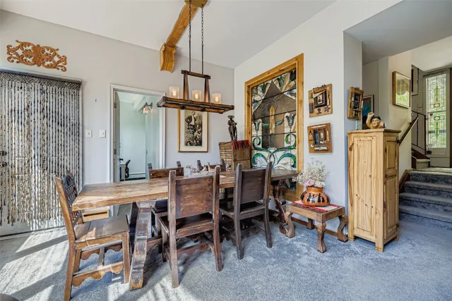 a view of a dining room with furniture and chandelier