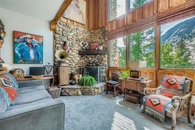 a living room with patio furniture and a fireplace