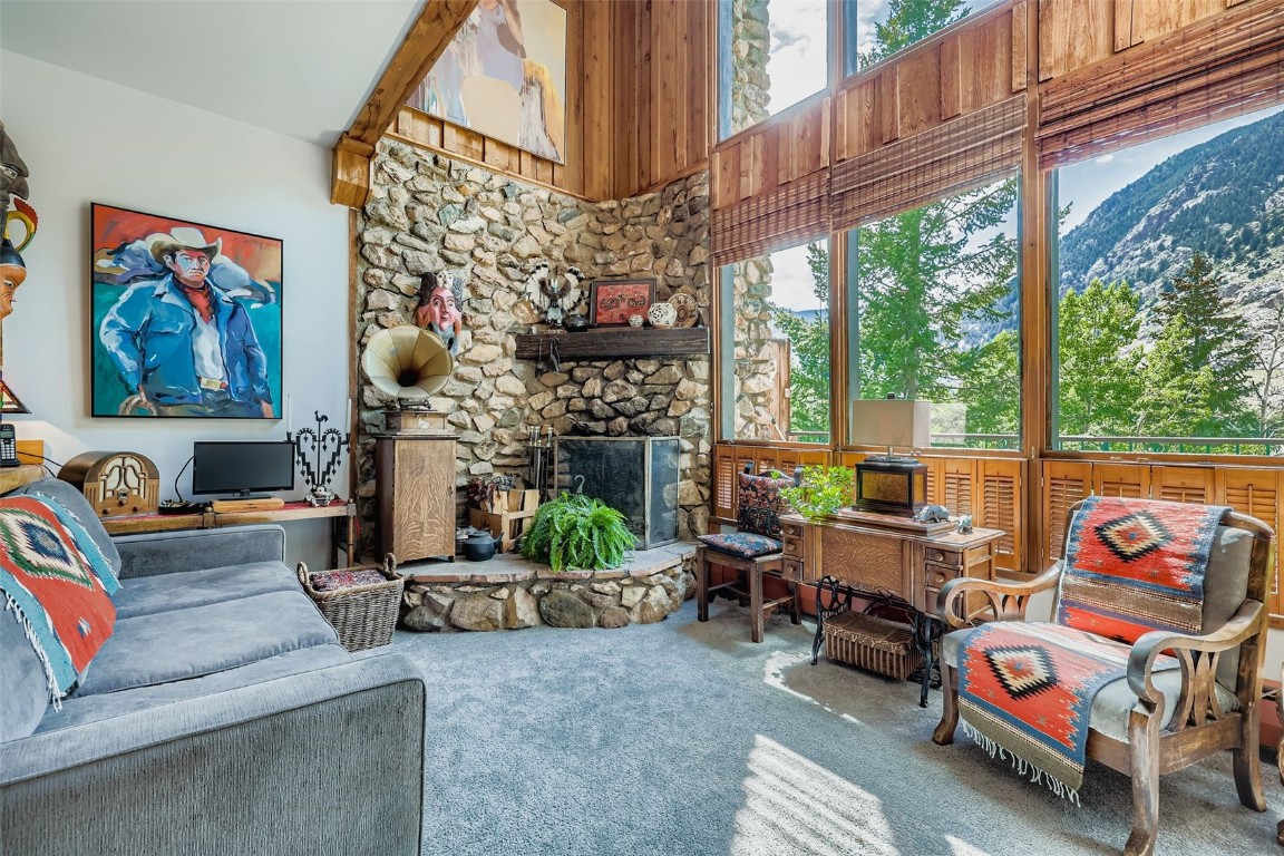 819 Valley View Drive Georgetown, CO 80444 - Photo 4 of 29 a living room with patio furniture and a fireplace
