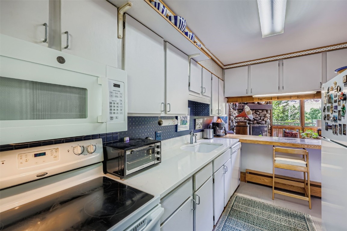 819 Valley View Drive Georgetown, CO 80444 - Photo 7 of 29 a kitchen with a sink a stove and cabinets