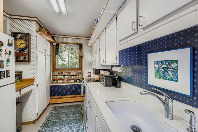 a bathroom with a tub sink and a large window
