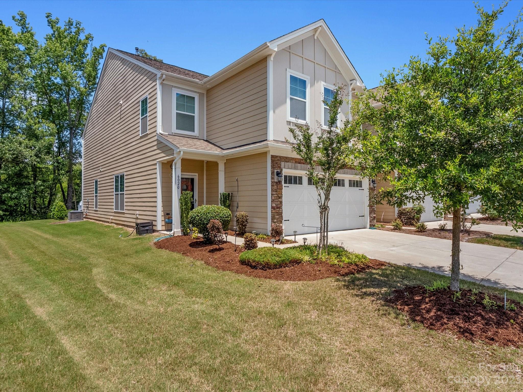 6020 Gribble Lane Lancaster, SC 29720 - Photo 1 of 32 a backyard of a house with table and chairs and potted plants