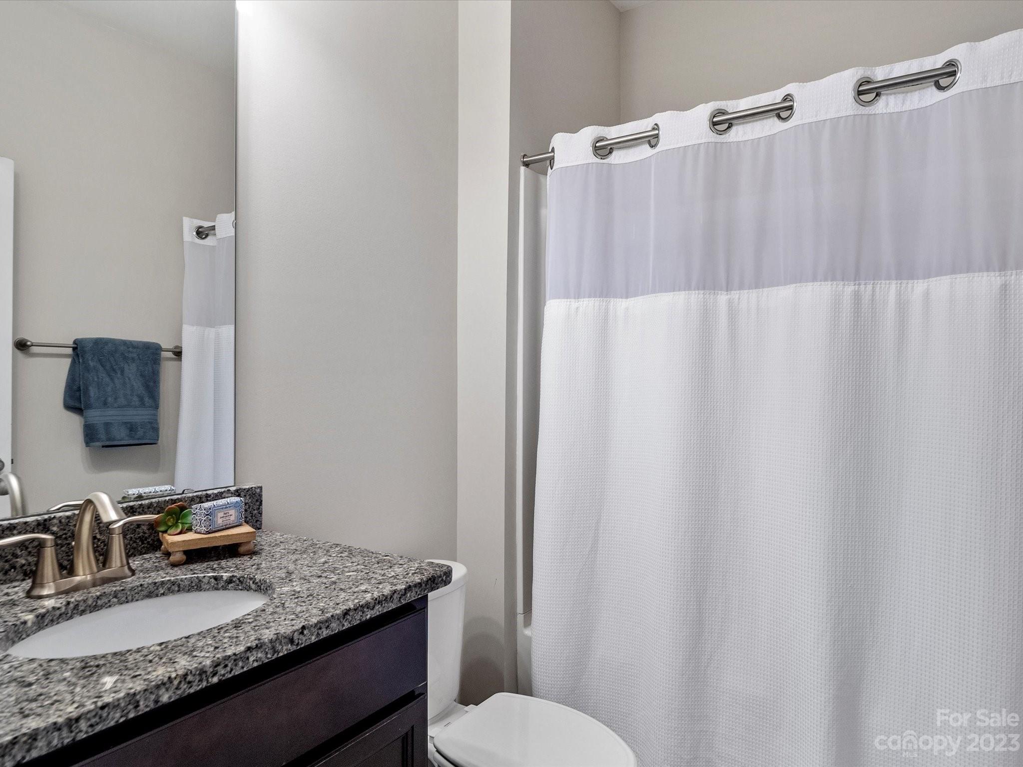 6020 Gribble Lane Lancaster, SC 29720 - Photo 17 of 32 a bathroom with a granite countertop sink and a mirror