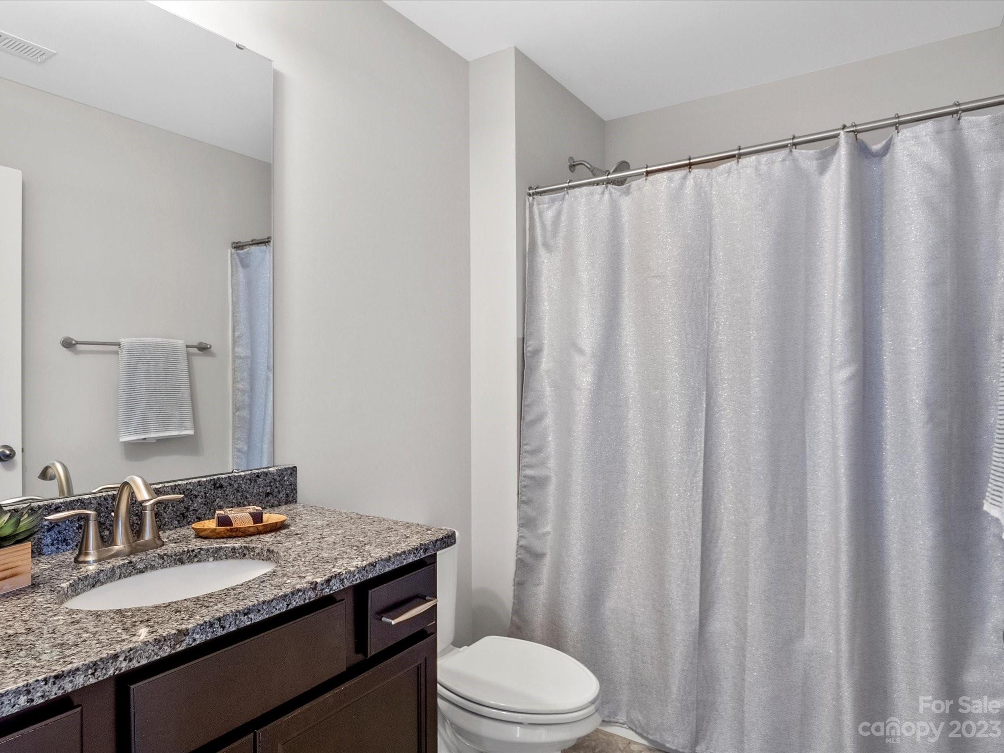 6020 Gribble Lane Lancaster, SC 29720 - Photo 27 of 32 a bathroom with a granite countertop sink and a mirror