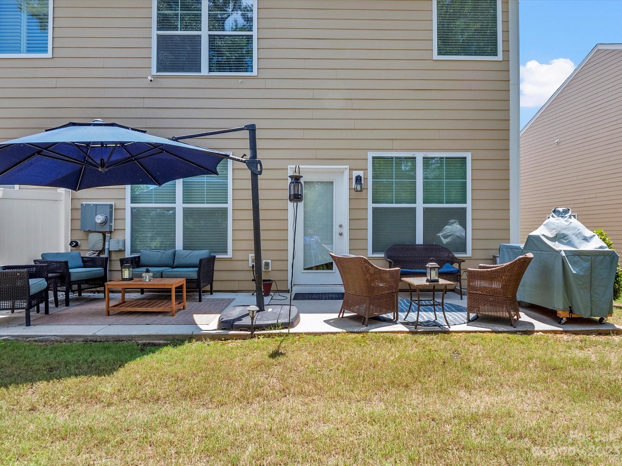 6020 Gribble Lane Lancaster, SC 29720 - Photo 30 of 32 a view of a patio with table and chairs under an umbrella
