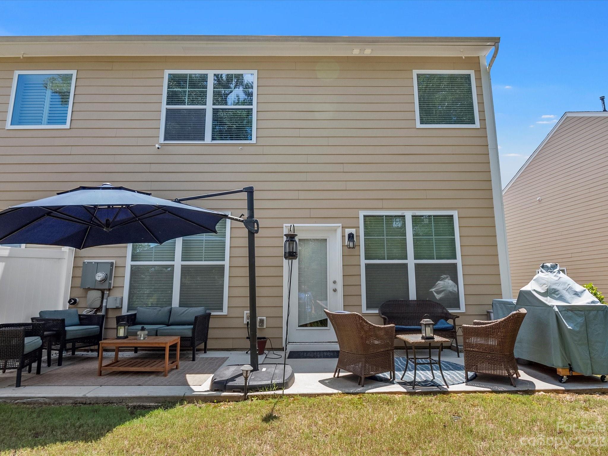 6020 Gribble Lane Lancaster, SC 29720 - Photo 31 of 32 a view of a patio with table and chairs under an umbrella