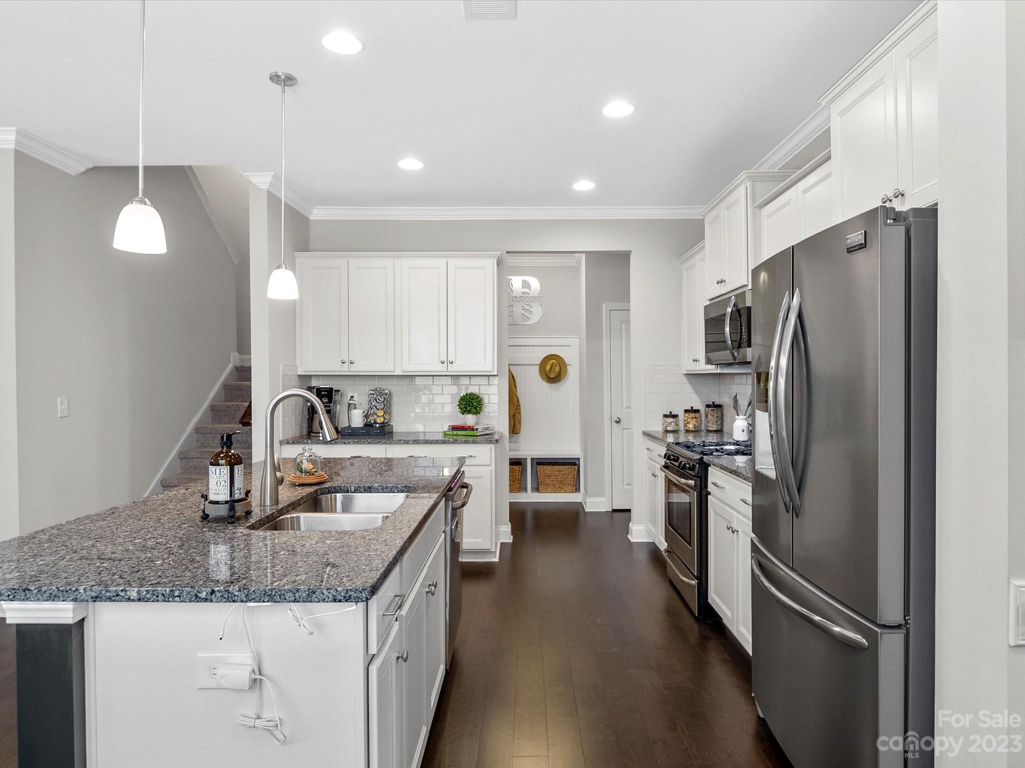 6020 Gribble Lane Lancaster, SC 29720 - Photo 6 of 32 a kitchen with stainless steel appliances granite countertop a refrigerator a sink dishwasher a stove with wooden cabinets