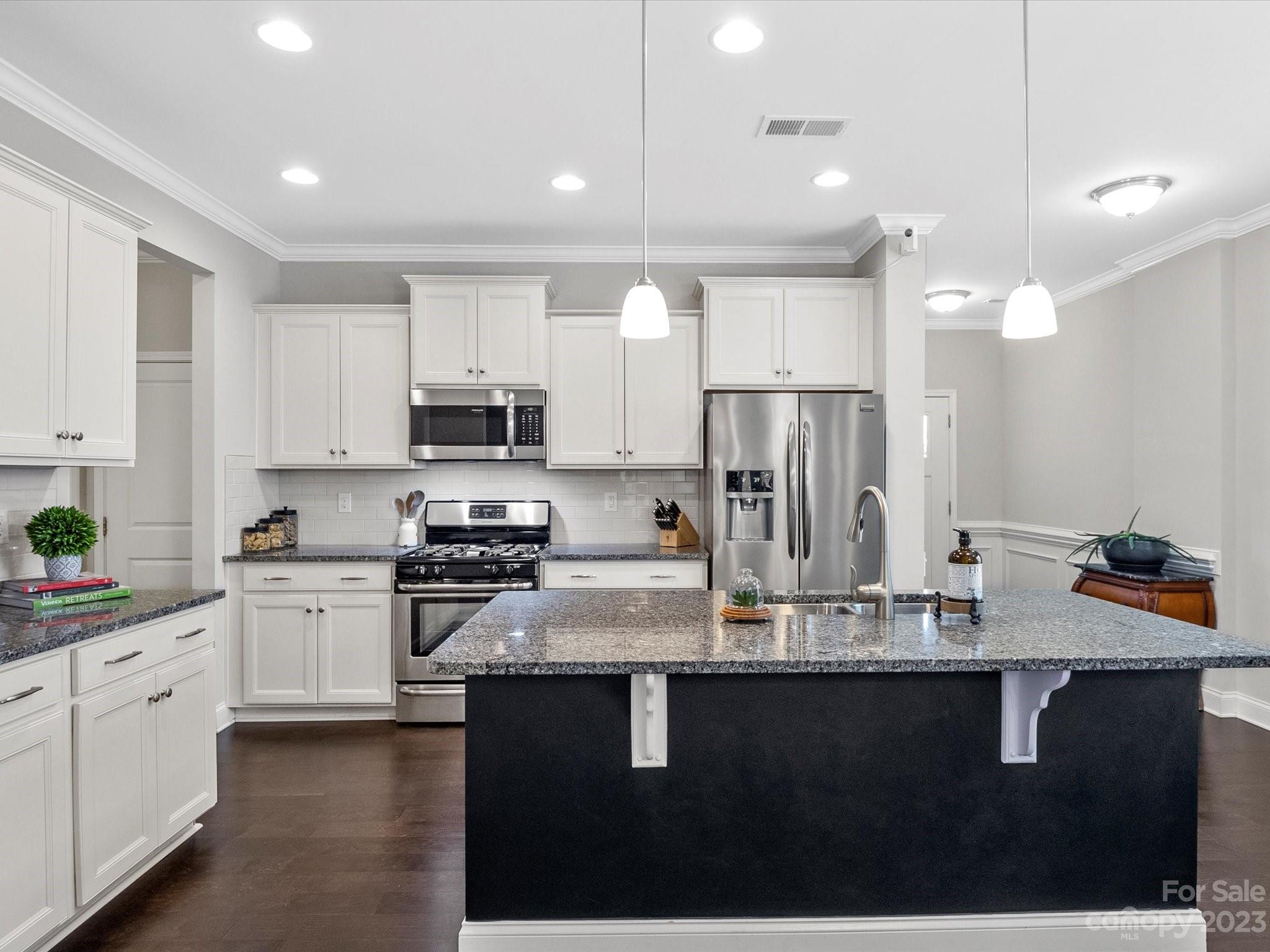 6020 Gribble Lane Lancaster, SC 29720 - Photo 8 of 32 a kitchen with kitchen island granite countertop a sink cabinets and stainless steel appliances