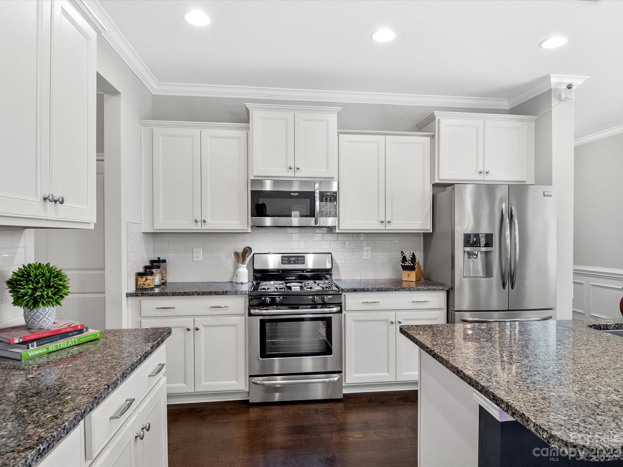 6020 Gribble Lane Lancaster, SC 29720 - Photo 9 of 32 a kitchen with granite countertop a sink stove and refrigerator