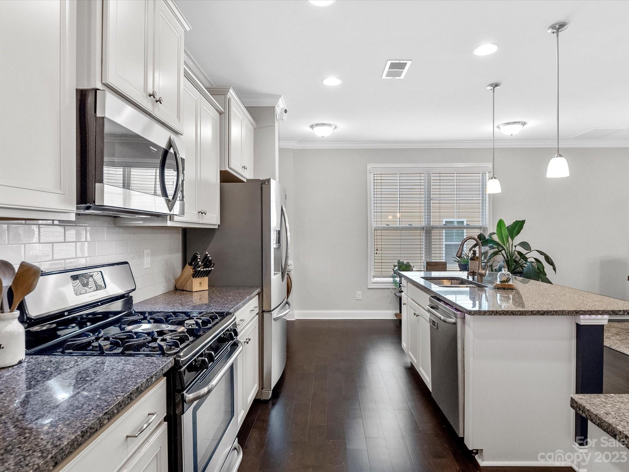 6020 Gribble Lane Lancaster, SC 29720 - Photo 10 of 32 a kitchen with stainless steel appliances granite countertop a sink stove and refrigerator