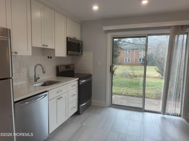 a kitchen with a sink a stove and a refrigerator