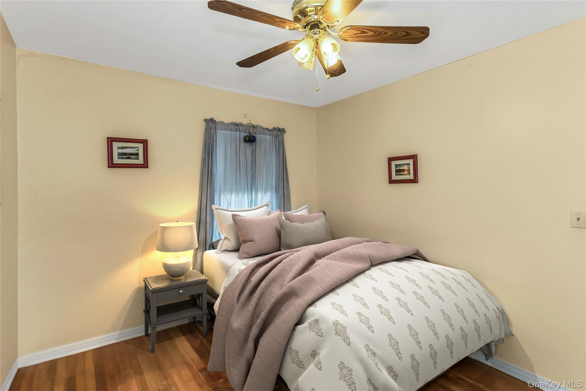 97 Horton Road Valley Stream, NY 11581 - Photo 14 of 21 a bedroom with a bed and a chandelier
