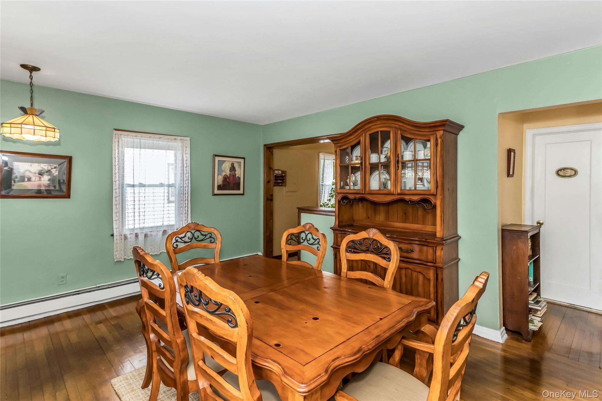 97 Horton Road Valley Stream, NY 11581 - Photo 5 of 21 a view of a dining room with furniture and wooden floor