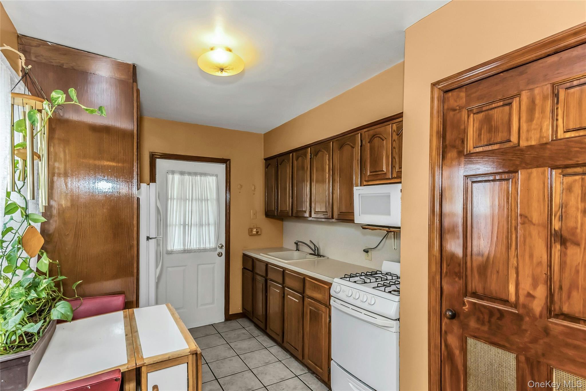 97 Horton Road Valley Stream, NY 11581 - Photo 6 of 21 a kitchen with stainless steel appliances granite countertop a refrigerator and a stove