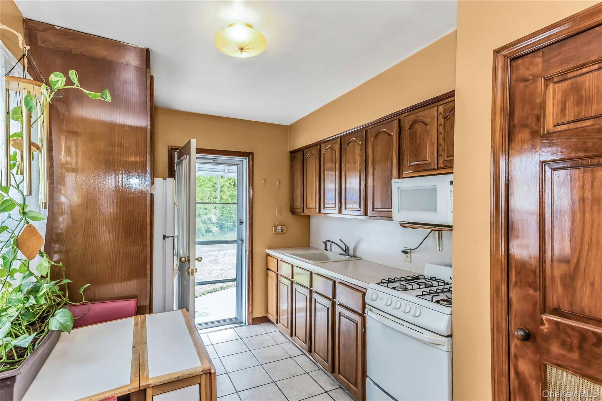 97 Horton Road Valley Stream, NY 11581 - Photo 7 of 21 a kitchen with stainless steel appliances granite countertop a refrigerator and a stove