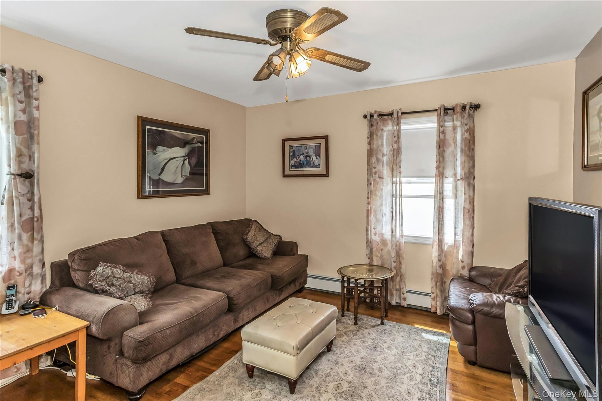 97 Horton Road Valley Stream, NY 11581 - Photo 10 of 21 a living room with furniture a flat screen tv and a window