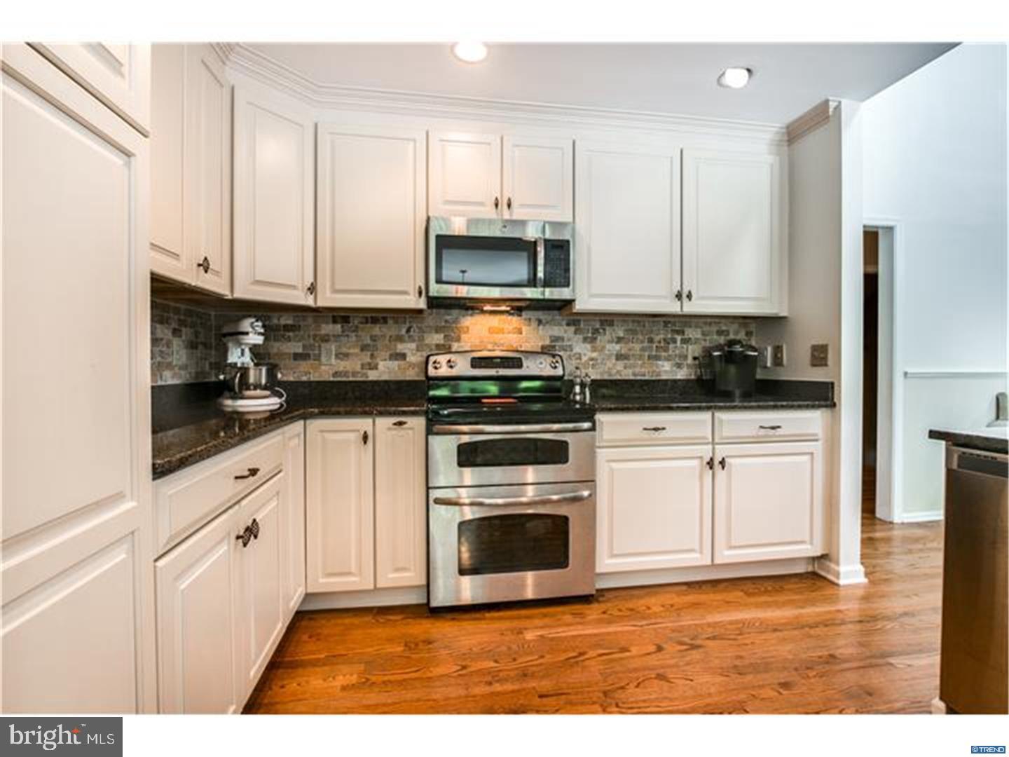 121 Hamilton Road Landenberg, PA 19350 - Photo 8 of 25 a kitchen with stainless steel appliances granite countertop a stove a sink and white cabinets
