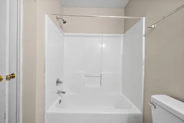 a bathroom with a bathtub and a toilet