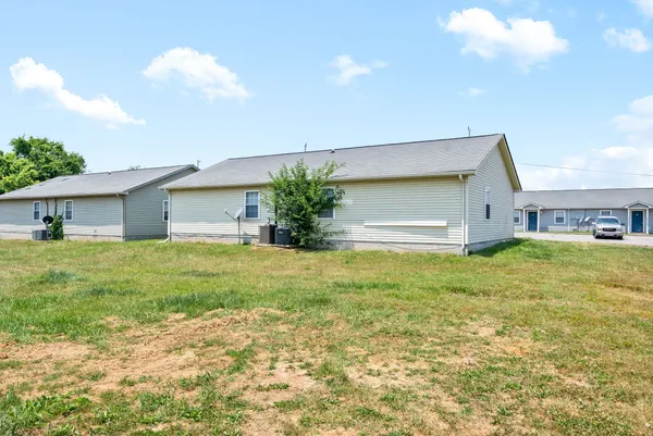 a front view of house with yard and garage