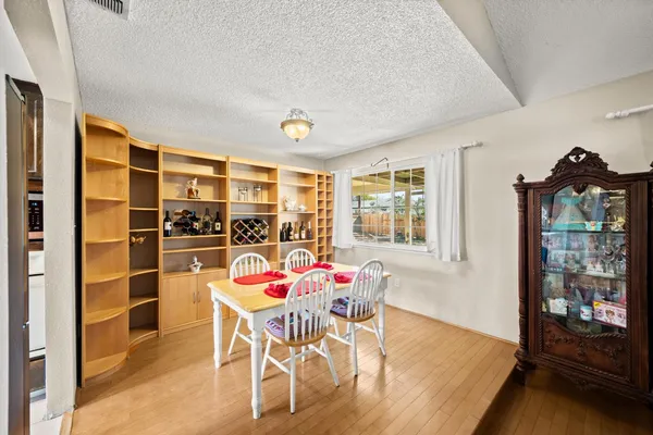 a view of a dining room with furniture and window