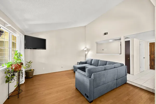 a living room with furniture and a flat screen tv