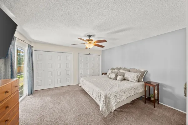 a bedroom with a large bed and a chandelier