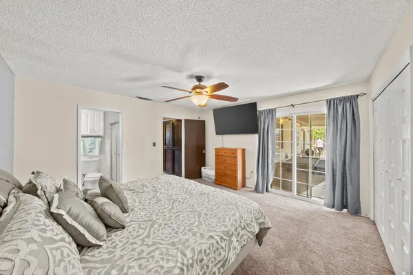 a bedroom with a large bed and a large window