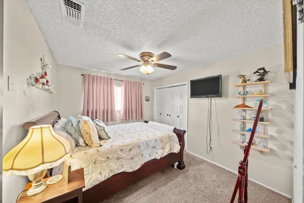 a bedroom with a bed and a flat screen tv
