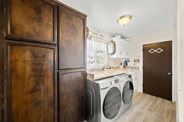 a kitchen with a refrigerator a washer and dryer