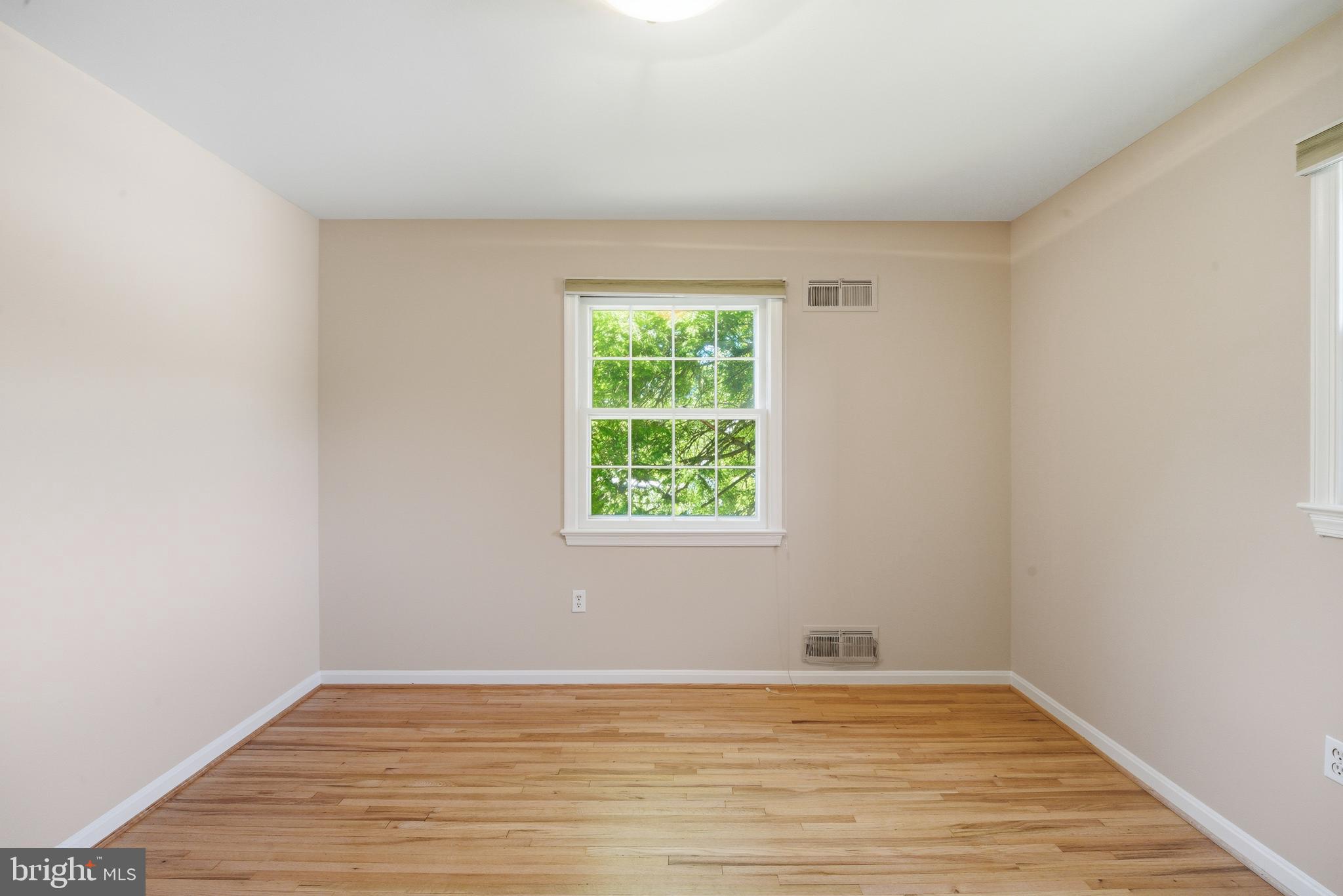 13309 Old Forge Road Silver Spring, MD 20904 - Photo 39 of 52 a view of an empty room with wooden floor and a window