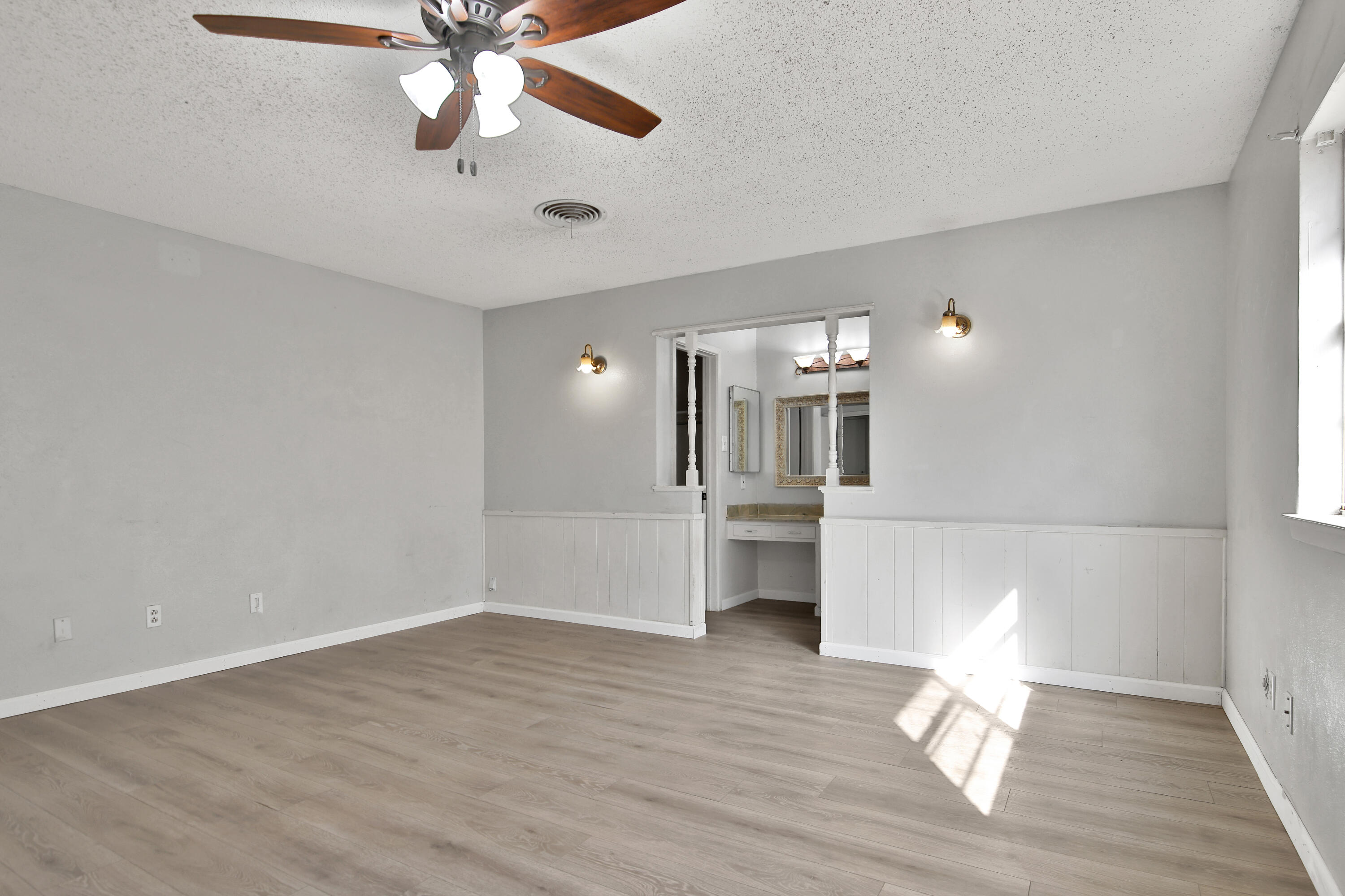 6607 Avenue U Lubbock, TX 79412 - Photo 12 of 25 a view of empty room with wooden floor and fan