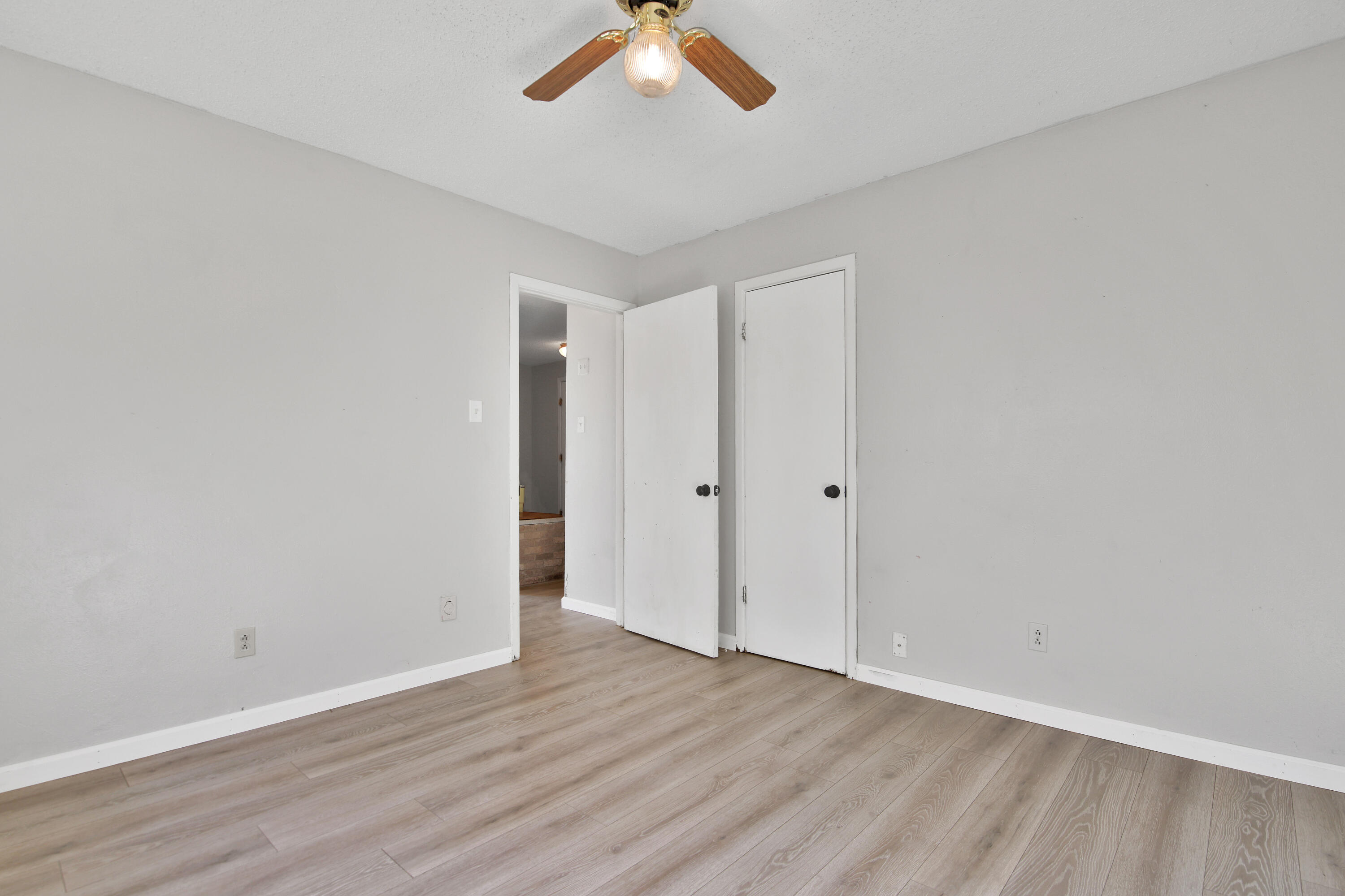 6607 Avenue U Lubbock, TX 79412 - Photo 20 of 25 an empty room with a ceiling fan and wooden floor