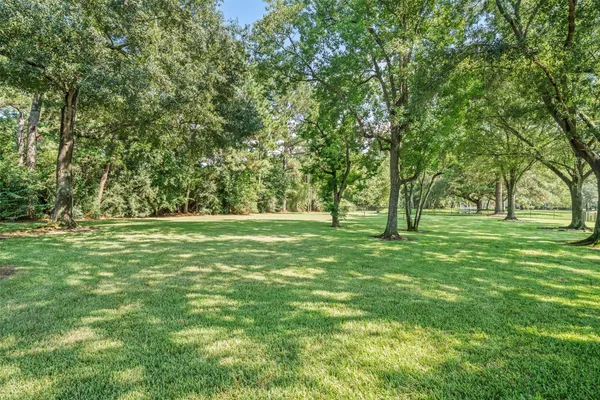 an aerial view of a house with swimming pool and garden