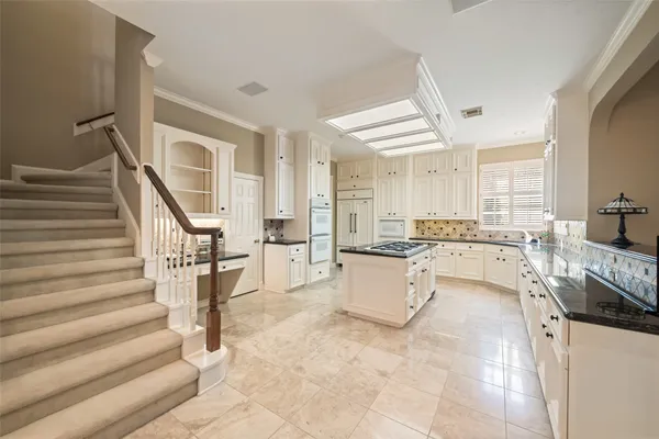 a kitchen with refrigerator and cabinets