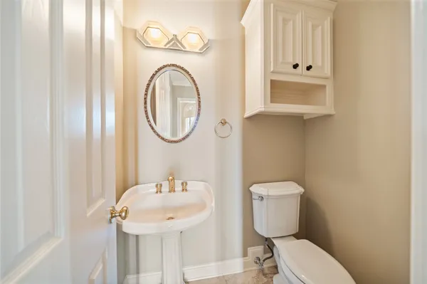 a kitchen with a refrigerator sink and cabinets