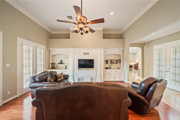 a view of a livingroom with wooden floor and windows