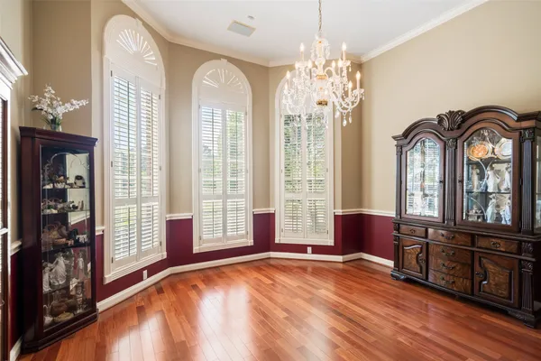 a living room with furniture and large windows