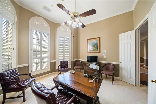 a living room with furniture flat screen tv and a large window