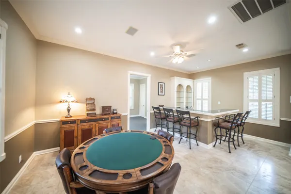 a bedroom with a large bed and ceiling fan
