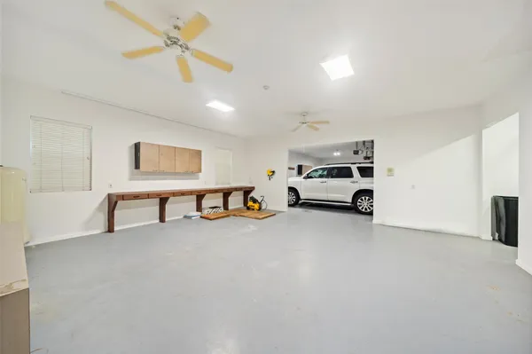 a view of staircase with lots of frames on wall and a window
