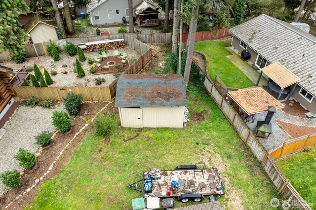 an aerial view of a house with a garden and mountain