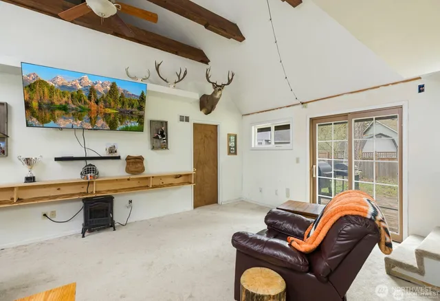 a living room with furniture cabinets and a window