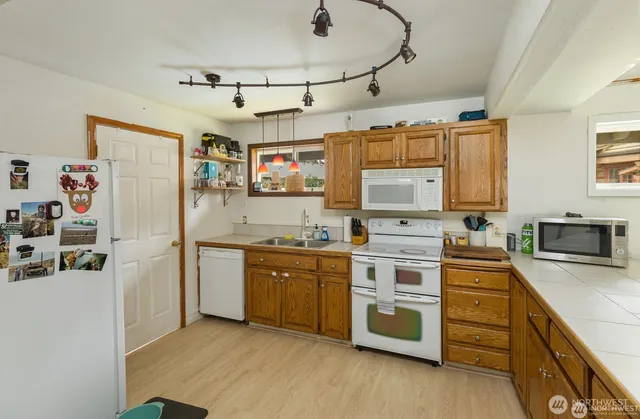 a kitchen with stainless steel appliances granite countertop a stove sink and refrigerator