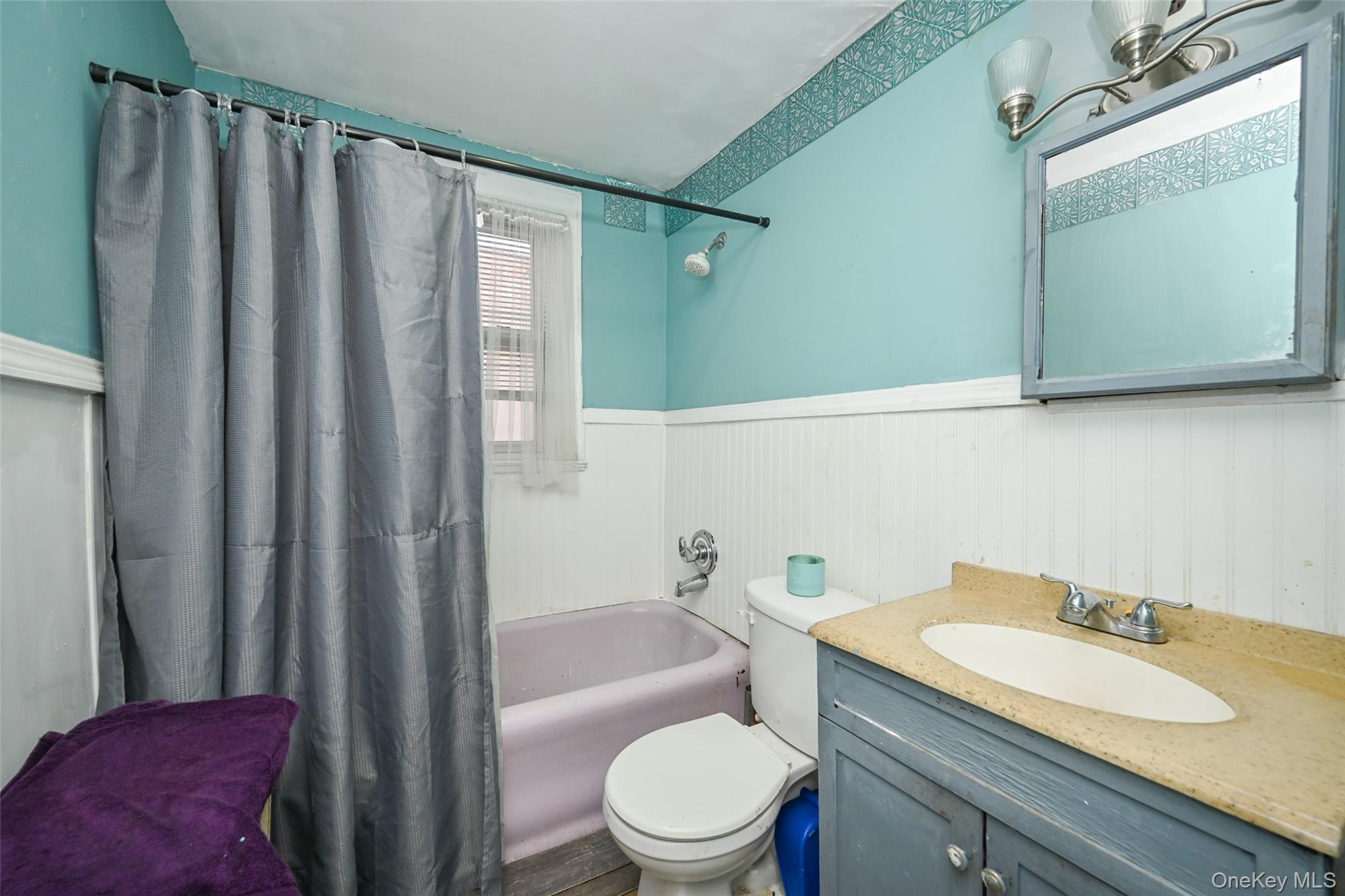 134-21 229th Street Queens, NY 11413 - Photo 11 of 25 a bathroom with a granite countertop sink toilet and shower