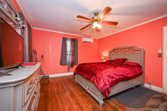 a bedroom with a bed and large windows