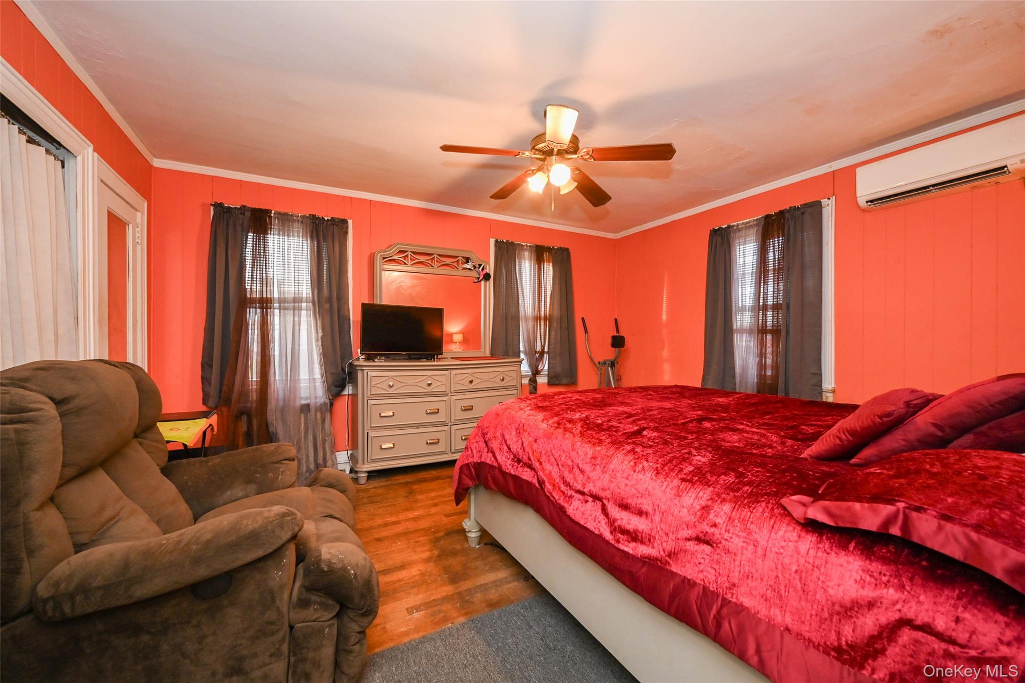 134-21 229th Street Queens, NY 11413 - Photo 16 of 25 a bedroom with a bed and large windows