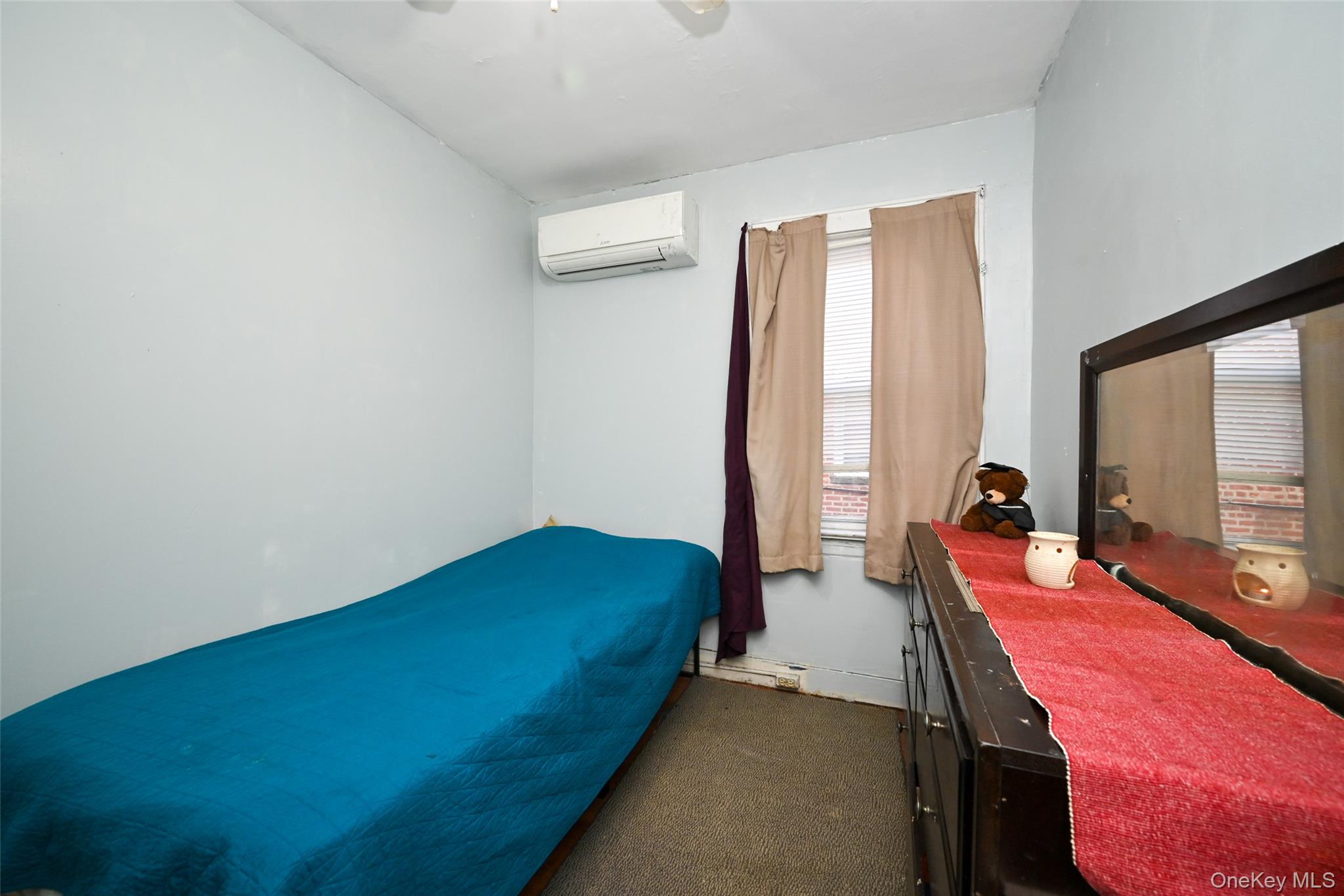 134-21 229th Street Queens, NY 11413 - Photo 18 of 25 a bedroom with a bed and a large window